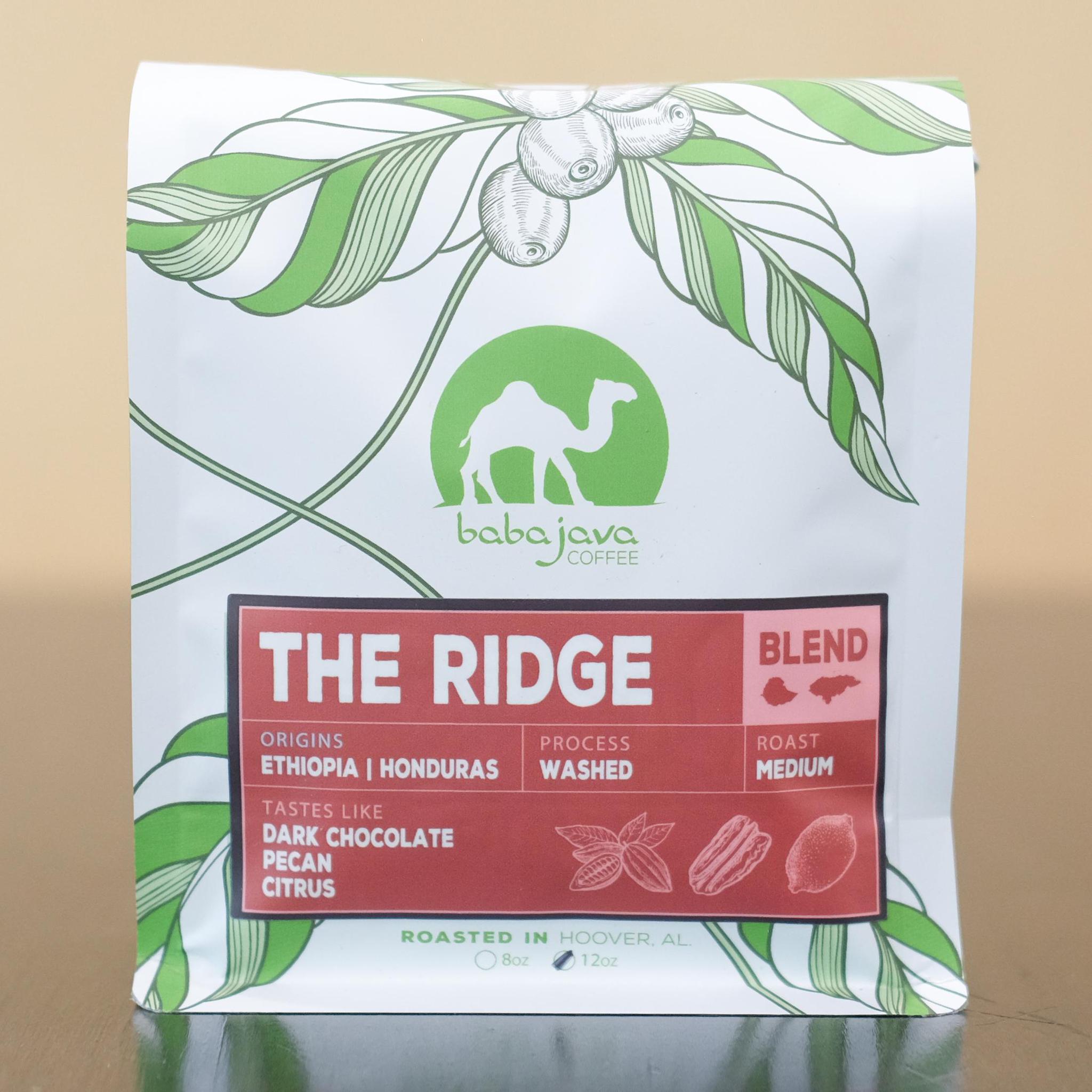 A bag of coffee with a red label that reads The Ridge Blend. The bag has a drawing of a coffee plant and the Baba Java Coffee logo.