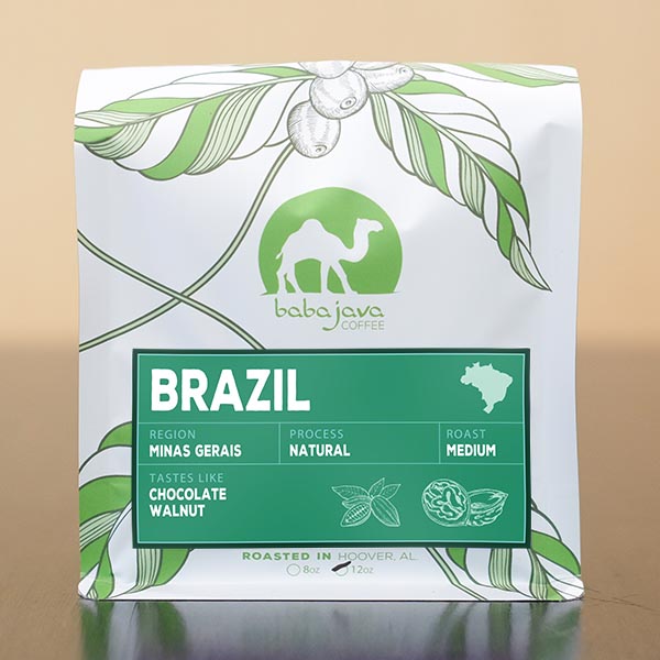 A bag of coffee with a light-green label that reads Brazil. The bag has a drawing of a coffee plant and the Baba Java Coffee logo.