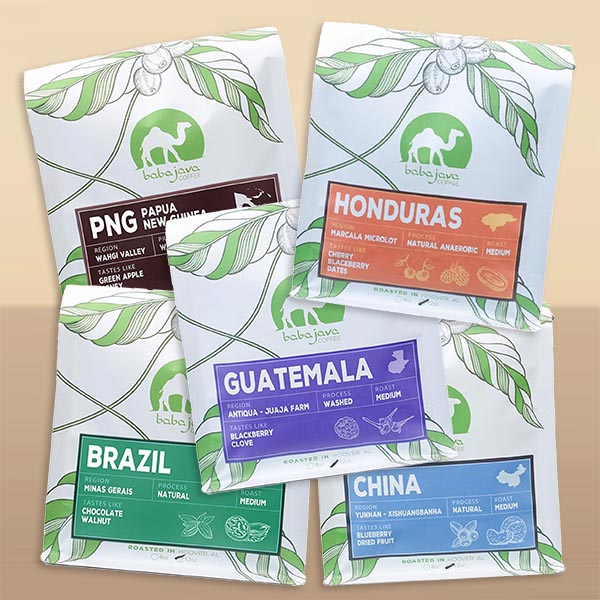 Five bags of coffee each with a different coffee origin label. There's Papua New Guinea, Honduras, Guatemala, Brazil, and China