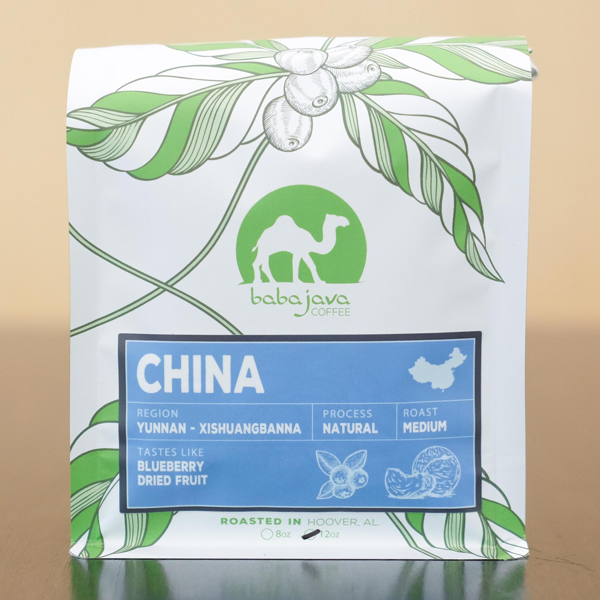 A bag of coffee with a light blue label that reads China. The bag has a drawing of a coffee plant and the Baba Java Coffee logo.