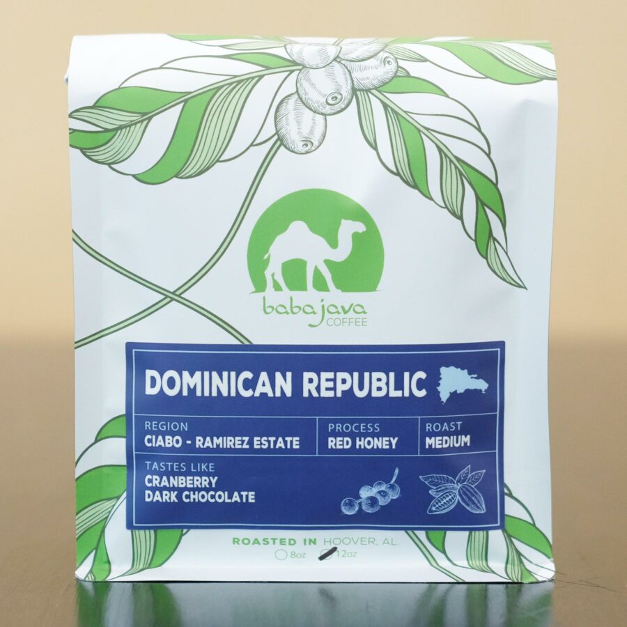 A bag of coffee with a blue label that reads Dominican Republic. The bag has a drawing of a coffee plant and the Baba Java Coffee logo.