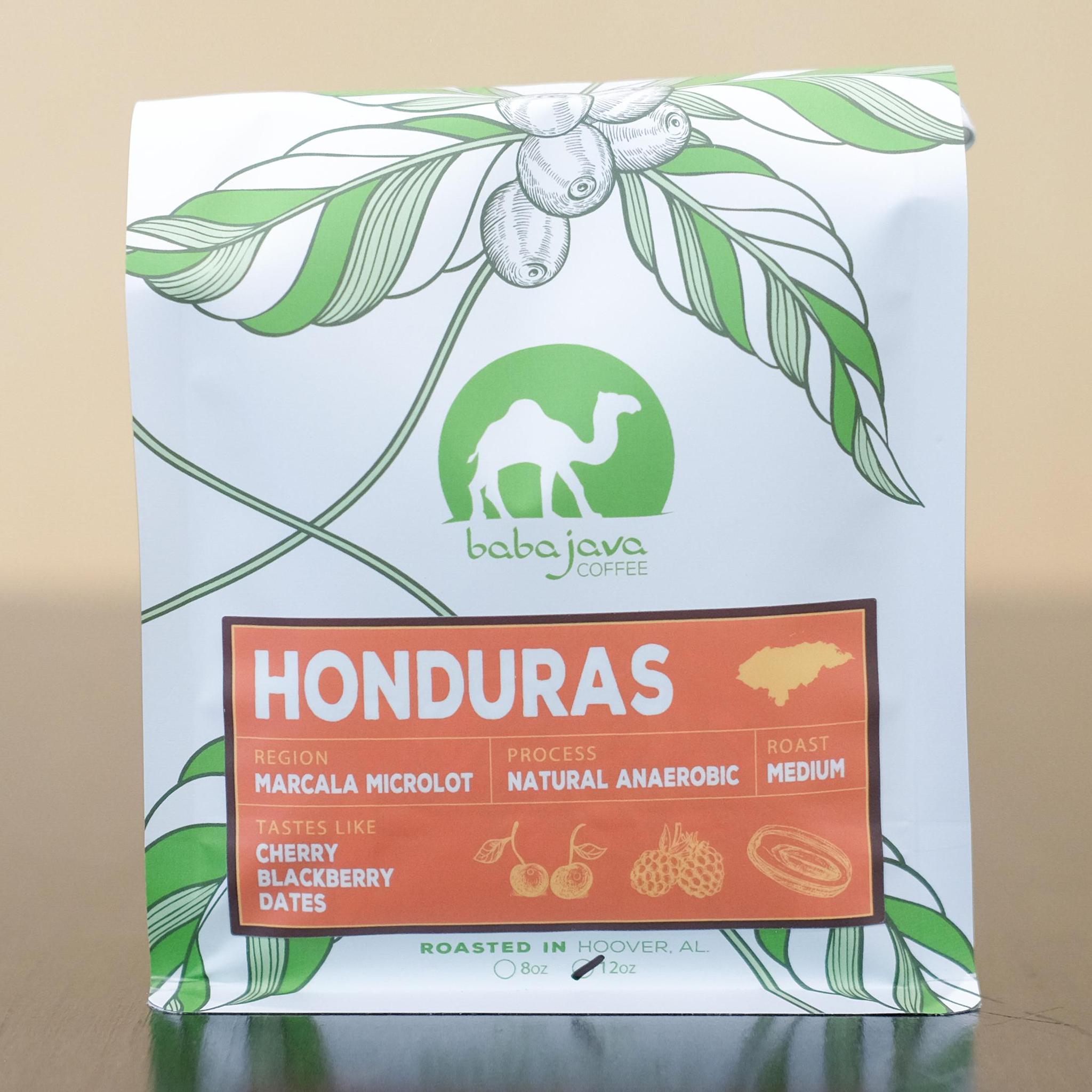 A bag of coffee with an orange label that reads Honduras. The bag has a drawing of a coffee plant and the Baba Java Coffee logo.