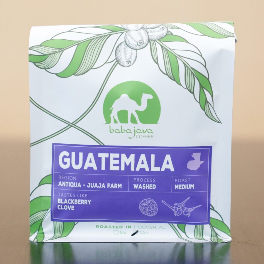A bag of coffee with a purple label that reads Guatemala. The bag has a drawing of a coffee plant and the Baba Java Coffee logo.